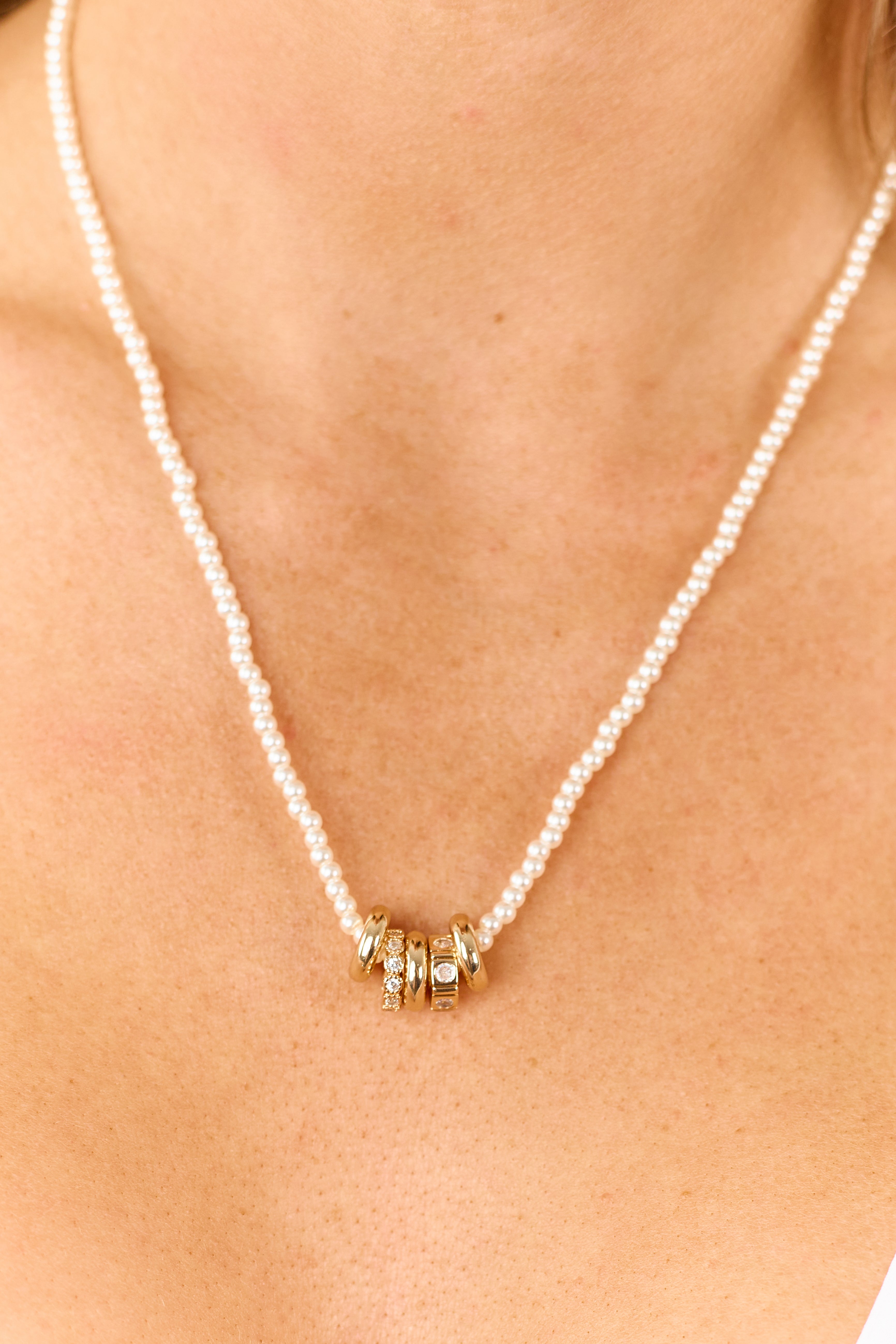 Collar de perlas con cuentas en tono dorado y dijes de anillos mixtos