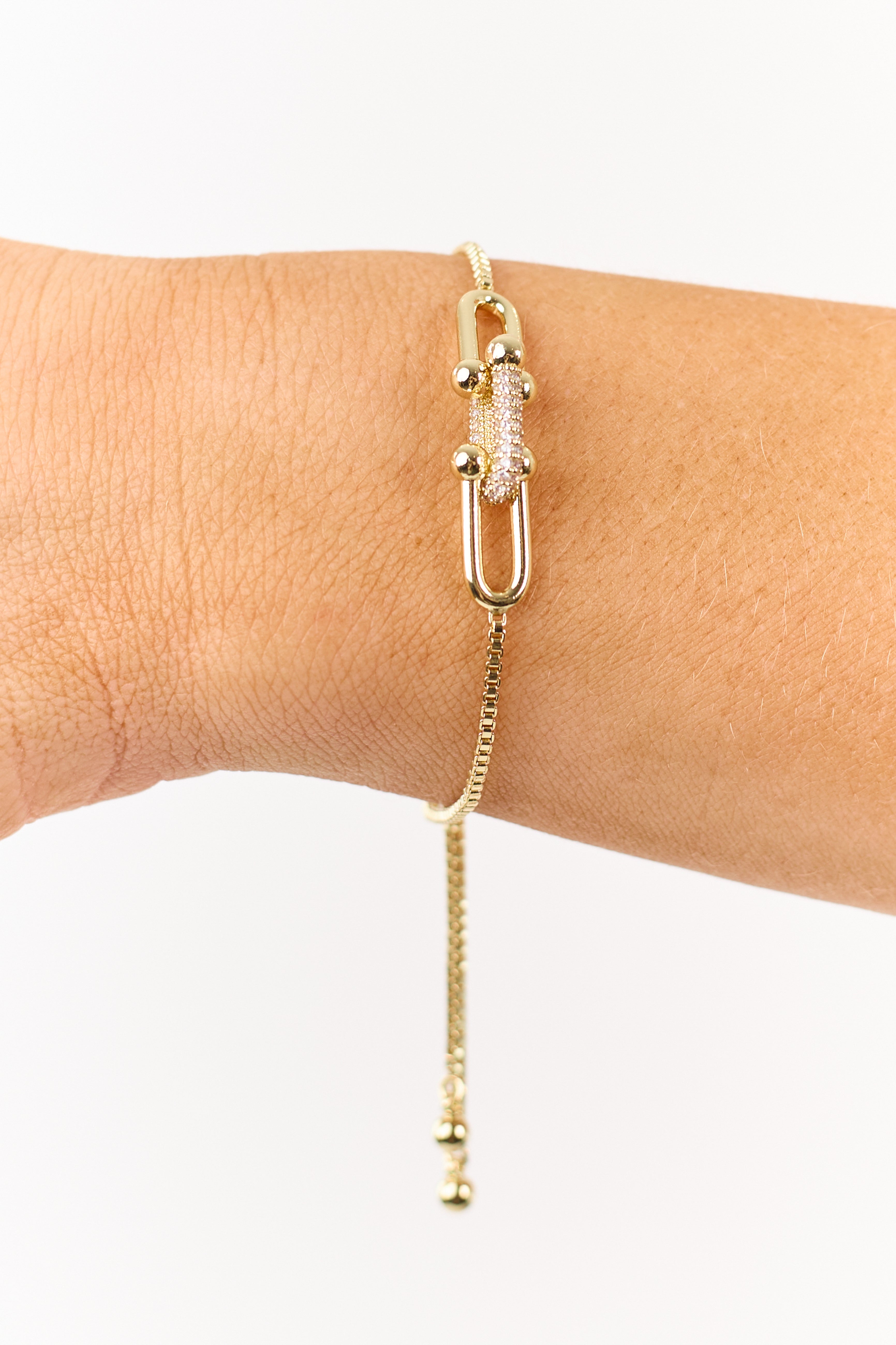 Colgante de eslabón dorado con cristales de strass en una pulsera de cadena tipo caja