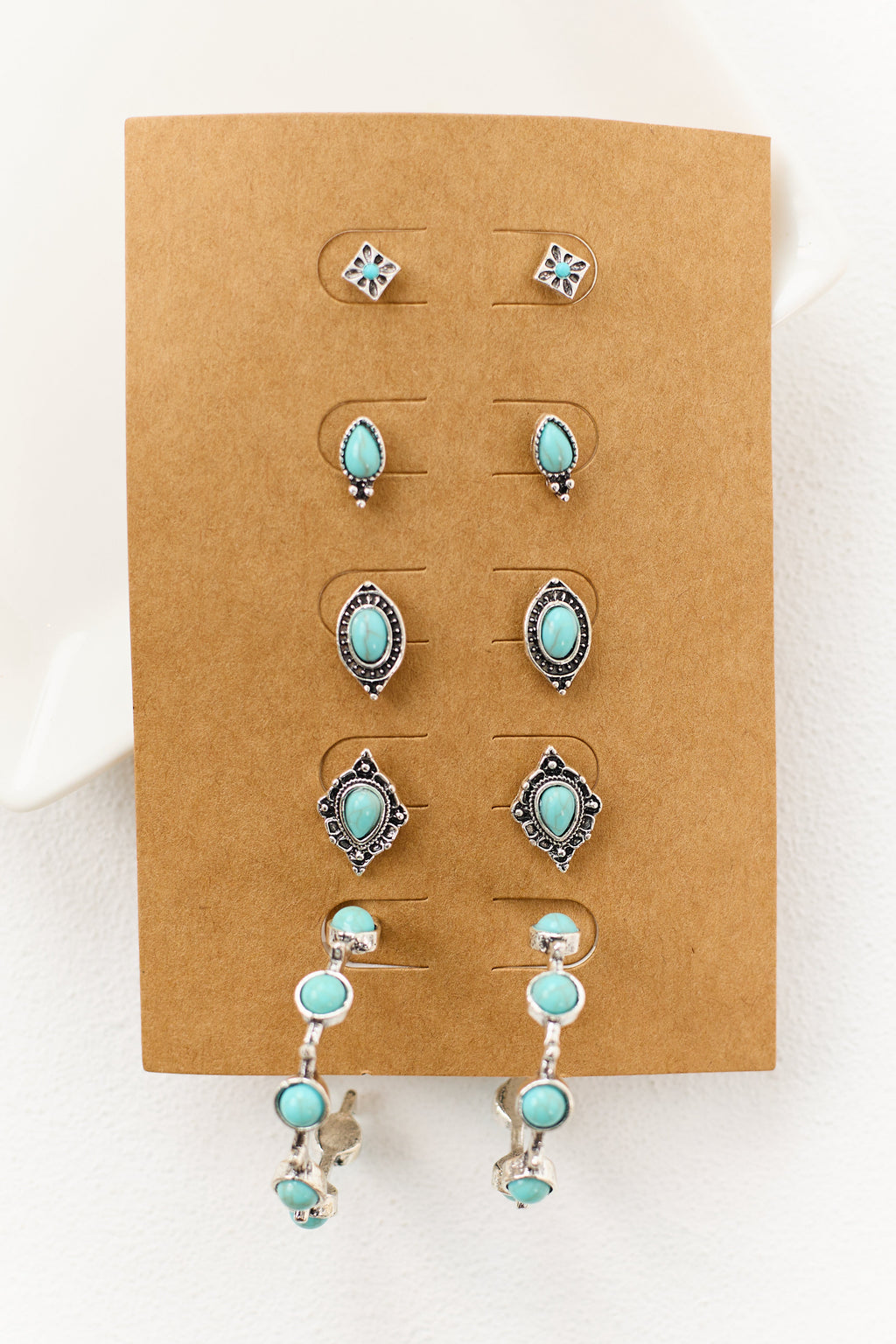 Conjunto de pendientes en tono plateado con piedra turquesa - estilos variados
